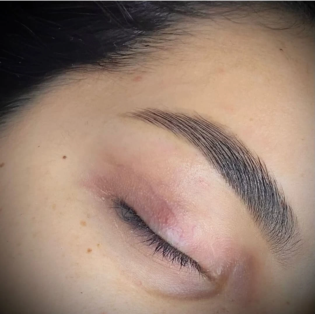 Close-up of perfectly shaped eyebrow on closed eye