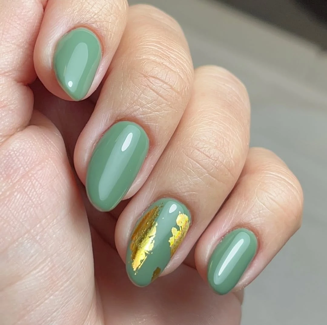 Olive green manicure with gold foil accent on ring finger