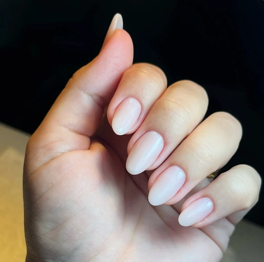 Soft milky pink natural nail set with subtle shimmer